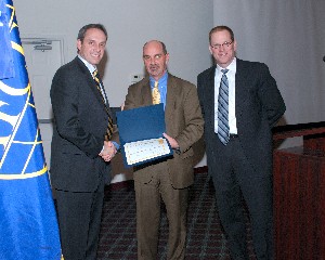 James Leftwich (l), president and chief executive officer, Dayton Development Coalition, accepts a token of appreciation from Dan Curtis (c), chapter vice president for programs, and Dave Judson, chapter president. Leftwich provided the keynote presentation at the January meeting.